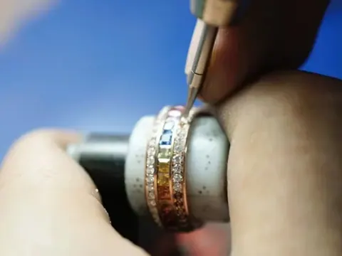 A rainbow sapphire and diamond ring being worked on the bench at BH Jewelry