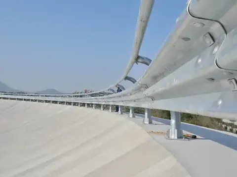 Galvanized W-beam guardrail sections stacked in the Hongda finished product area