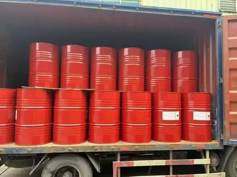 Red steel drums of isocyanate raw material loaded in a shipping container