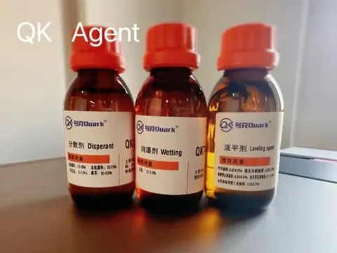 Three amber sample bottles of QK dispersant, wetting agent and levelling agent