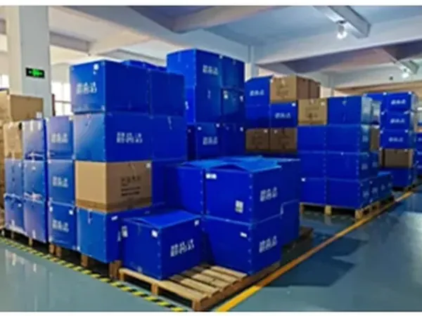 Finished-goods staging. Cartons are palletised by model so a mixed container of irrigators and whitening kits — ABrite Tech