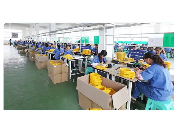 DANQ assembly line with workers building mosquito swatter heads