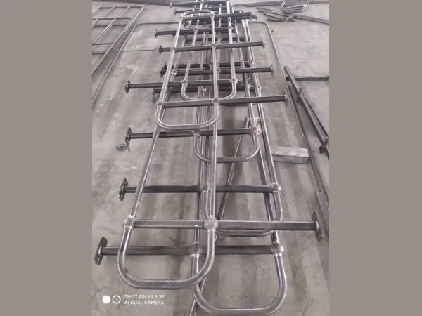 Ball joint stanchions and handrail tubes laid out on the workshop floor before galvanizing — Shengjingye (China)