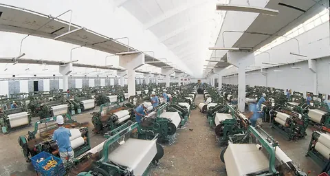Cotton weaving hall with rows of looms