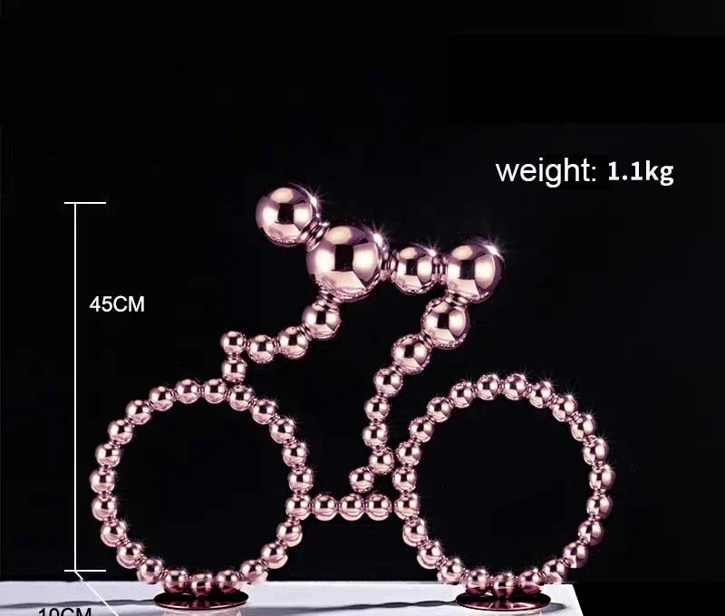 Rose gold metallic beaded bicycle sculpture on black background with weight and dimension annotations
