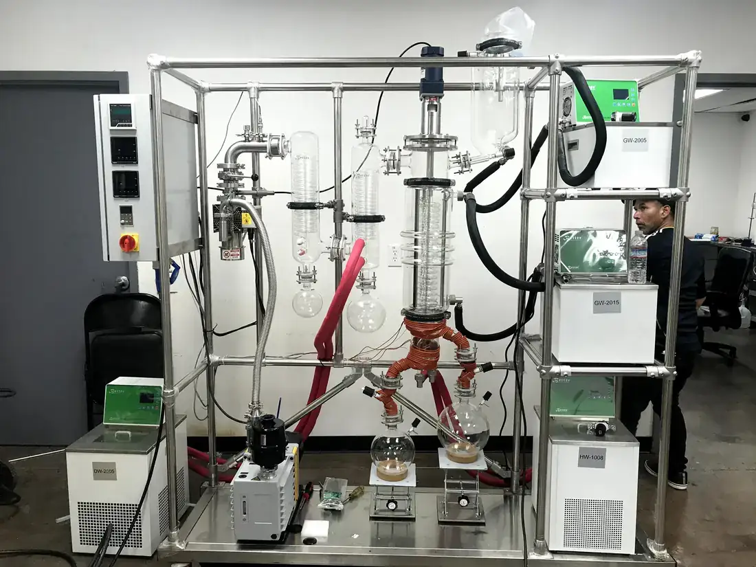 Short path distillation unit with condenser and receiving flasks