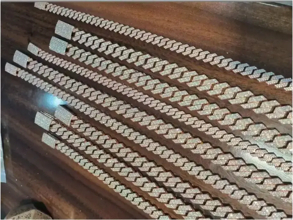 Diamond-set Cuban link chains laid out in a row after production at BH Jewelry