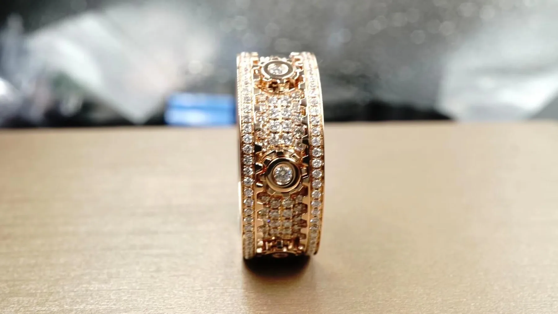 An ornate rose gold diamond band ring photographed during finishing at BH Jewelry