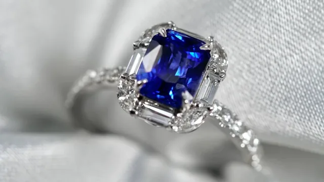 A blue sapphire and diamond halo engagement ring made by BH Jewelry