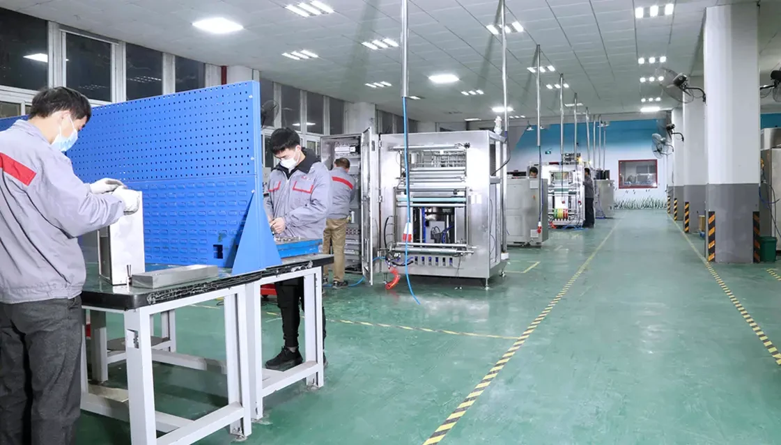 Boevan technicians assembling a pouch packaging machine frame in the workshop