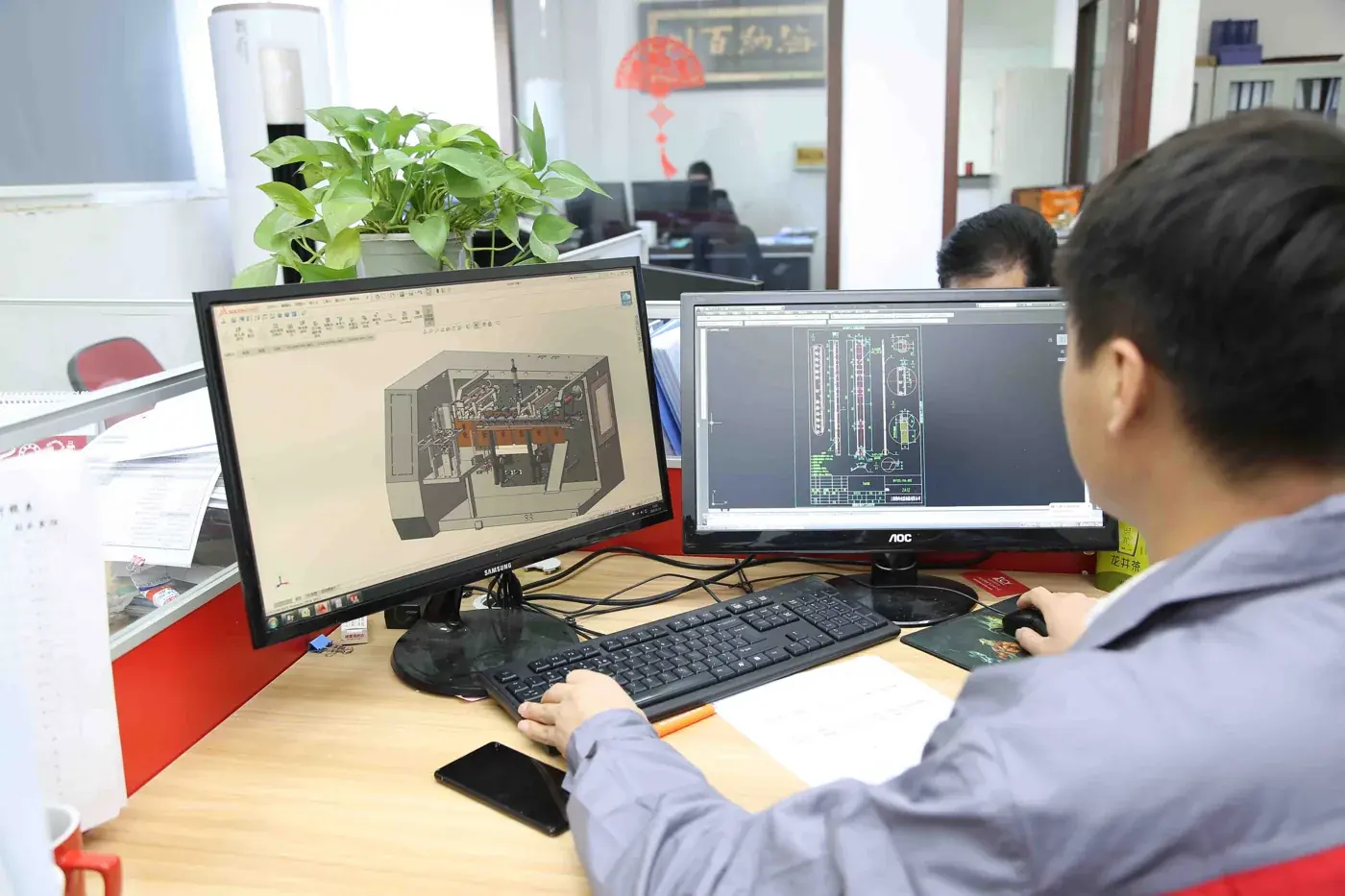 Boevan engineers working on a machine layout design