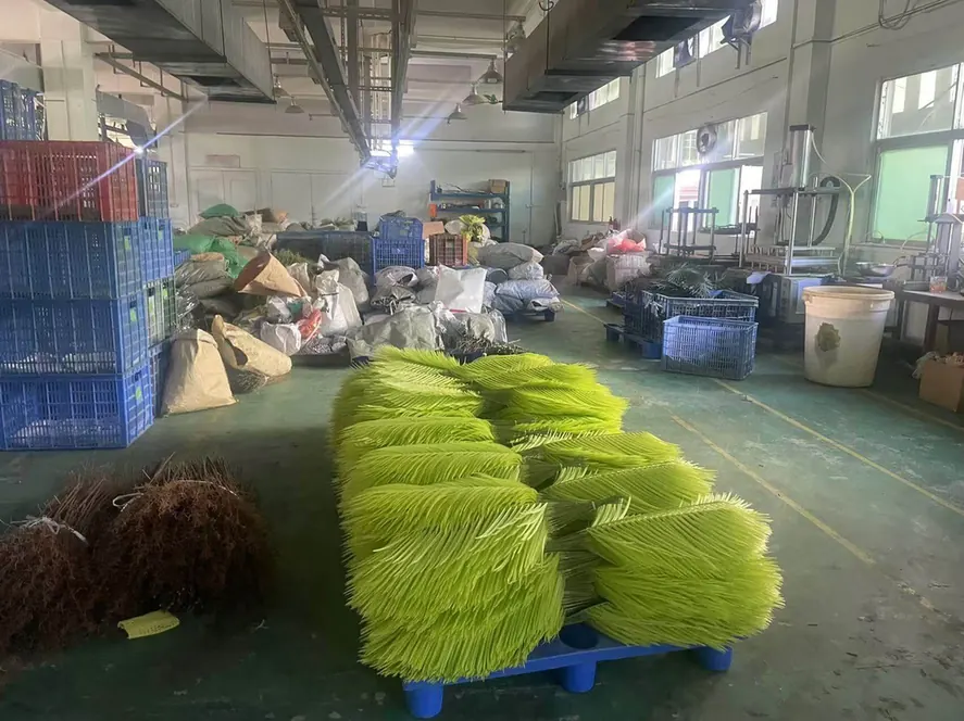 Freshly moulded artificial palm fronds stacked on a pallet in the workshop