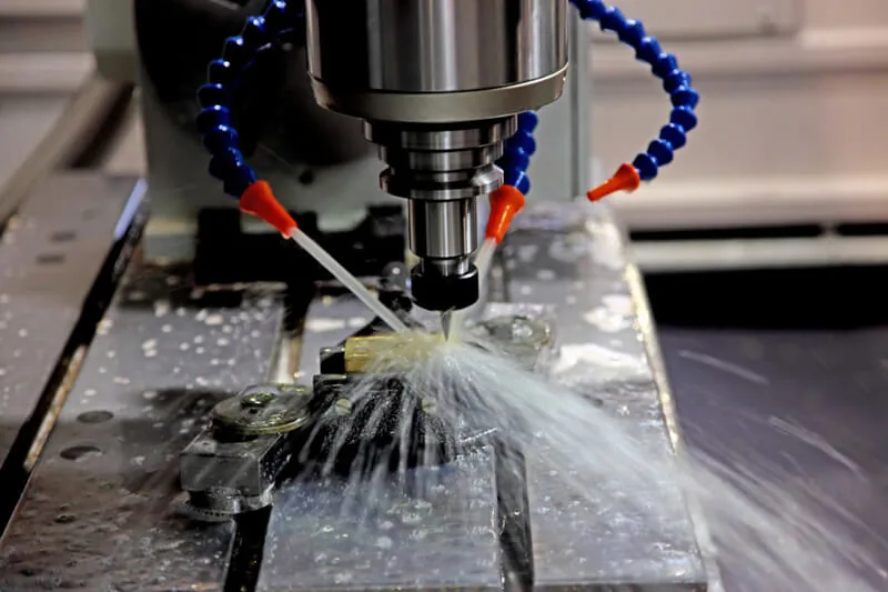 CNC milling machine cutting a metal part