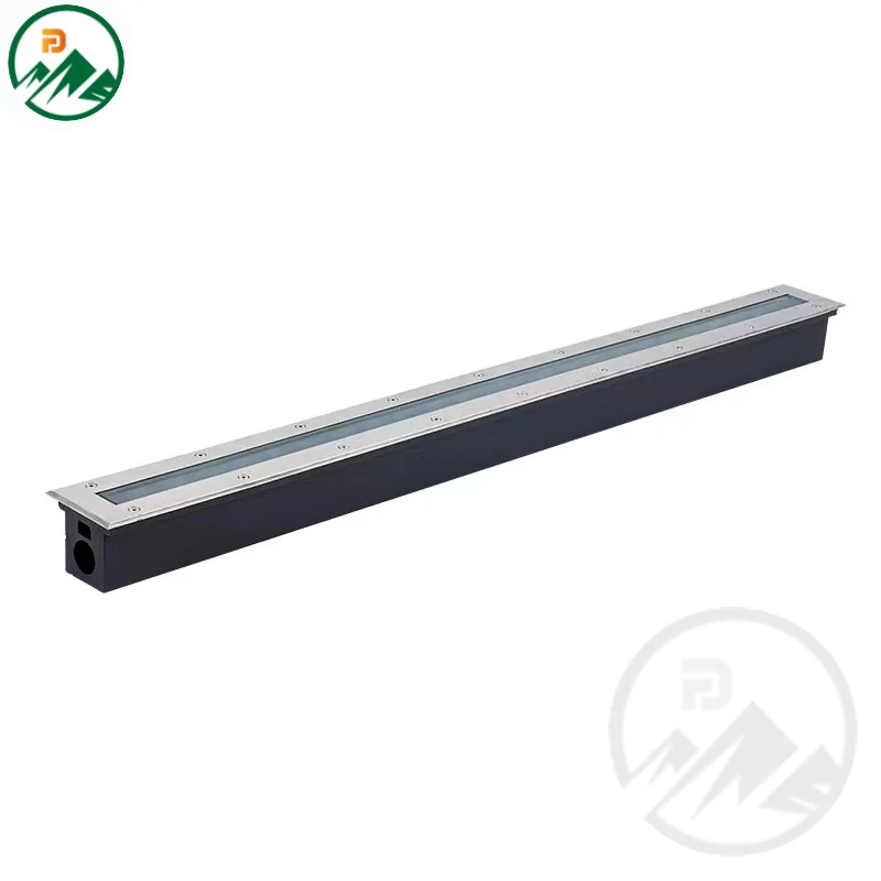 Linear in-ground luminaire installed flush in paving with the cover aligned to the surface