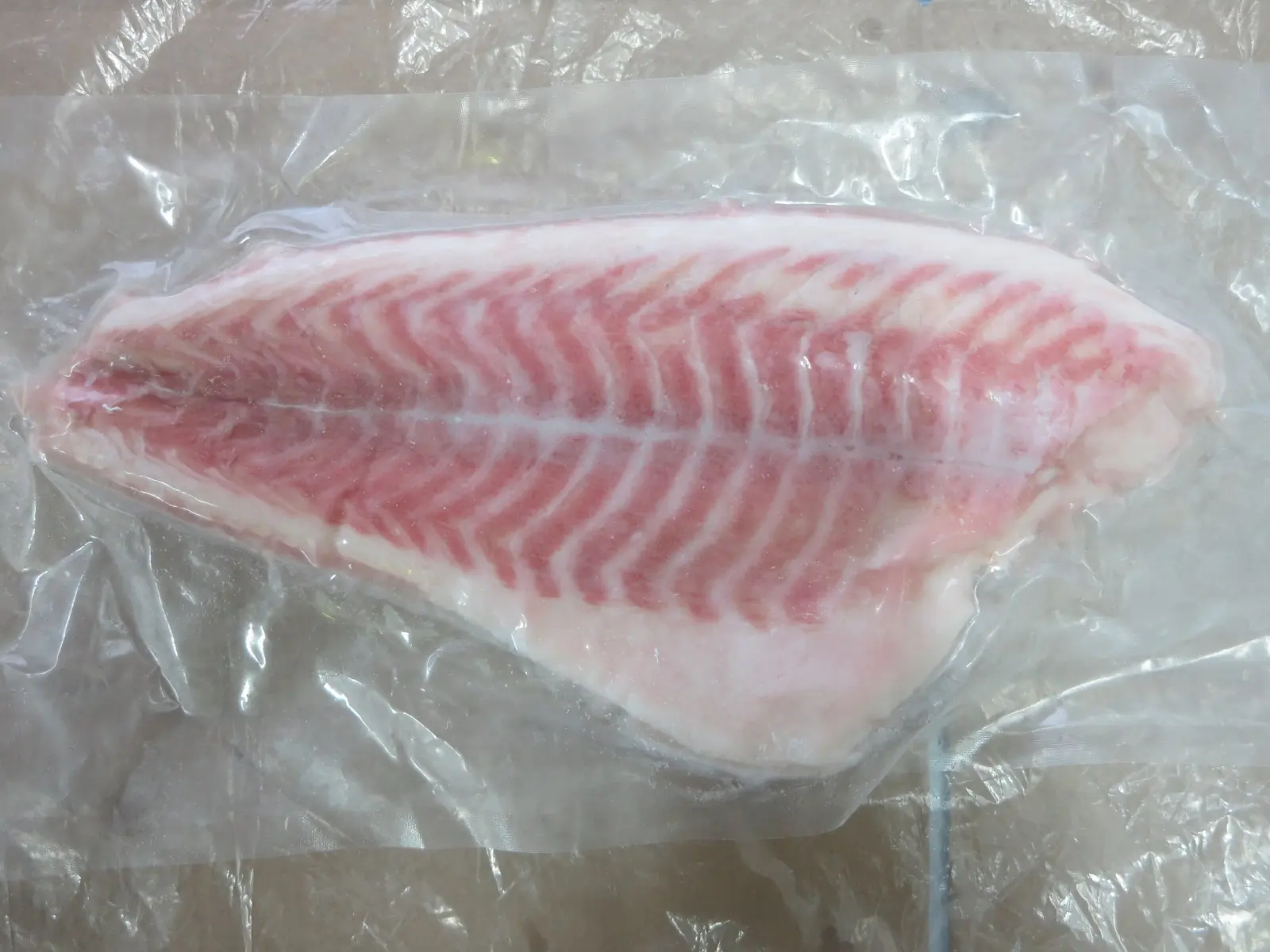 Packed skinless red drum fillet portion ready for freezing
