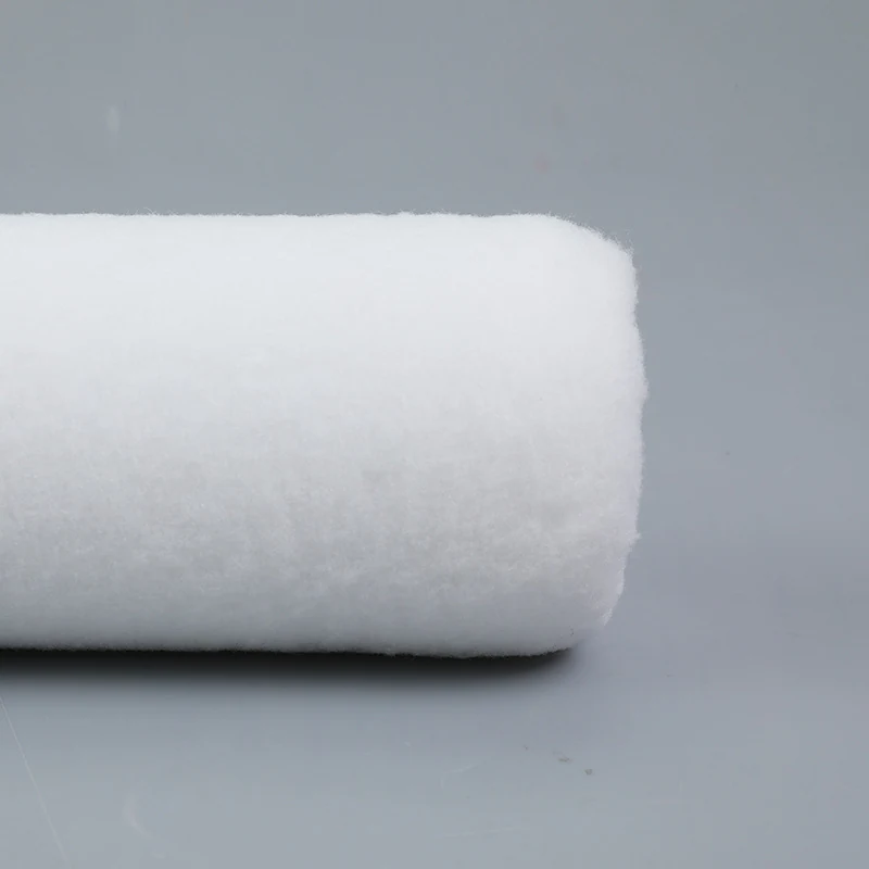 Close view of a white fibre roller cover showing pile density