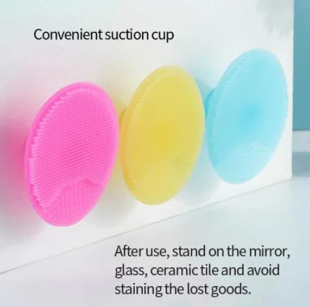 Silicone baby brush in use during a bath, with water droplets