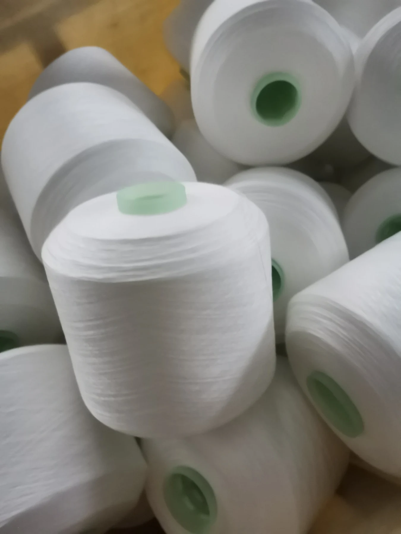 100% Spun Polyester Yarn 30S/3 on cone at the Hubei HuiLai Textile mill