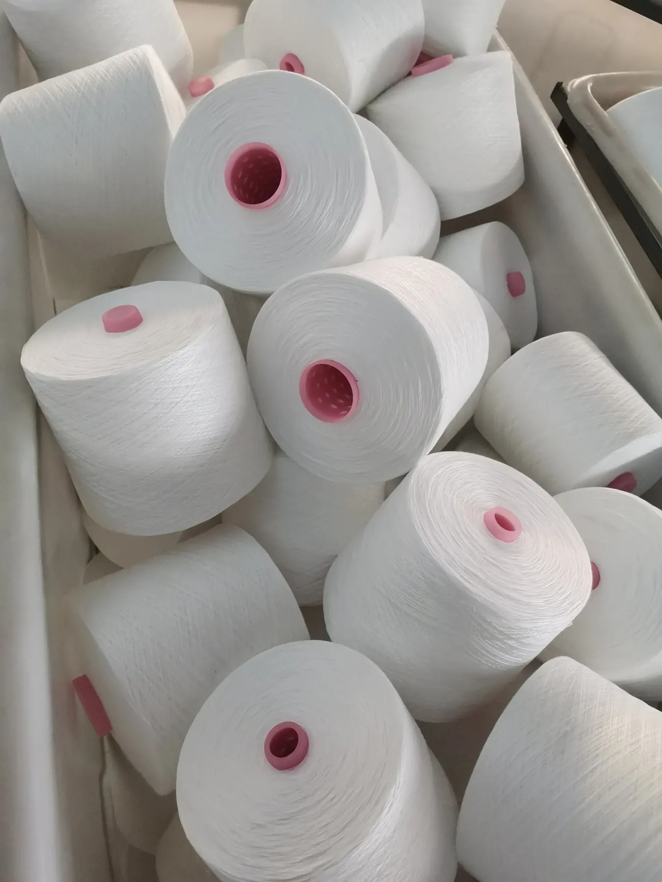 100% Spun Polyester Yarn 45S/2 on cone at the Hubei HuiLai Textile mill