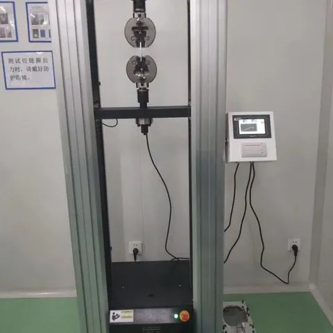 Tensile testing machine for cover and liner adhesion and material strength.