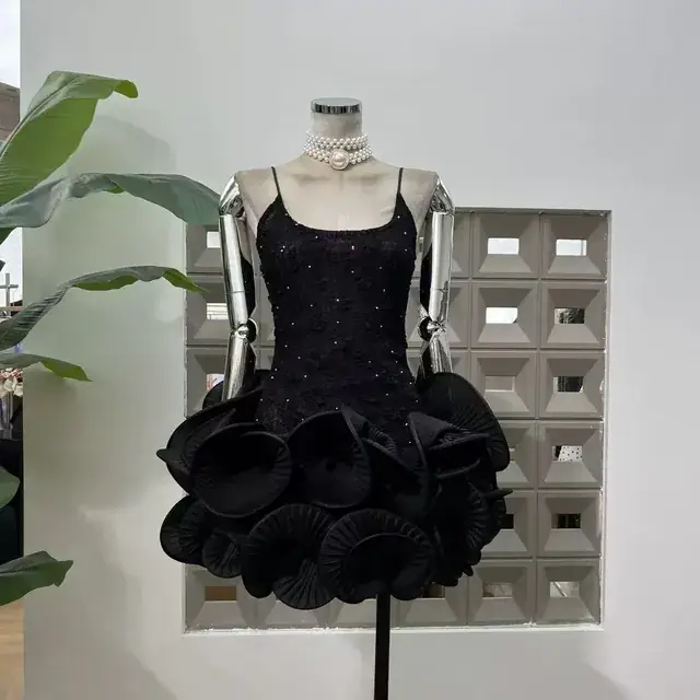 Black beaded lace mini dress with sculptural circular rosette hem