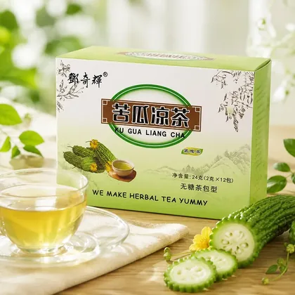 Box of Ku Gua Liang Cha herbal tea beside a glass cup of tea and sliced bitter melon on a wooden table