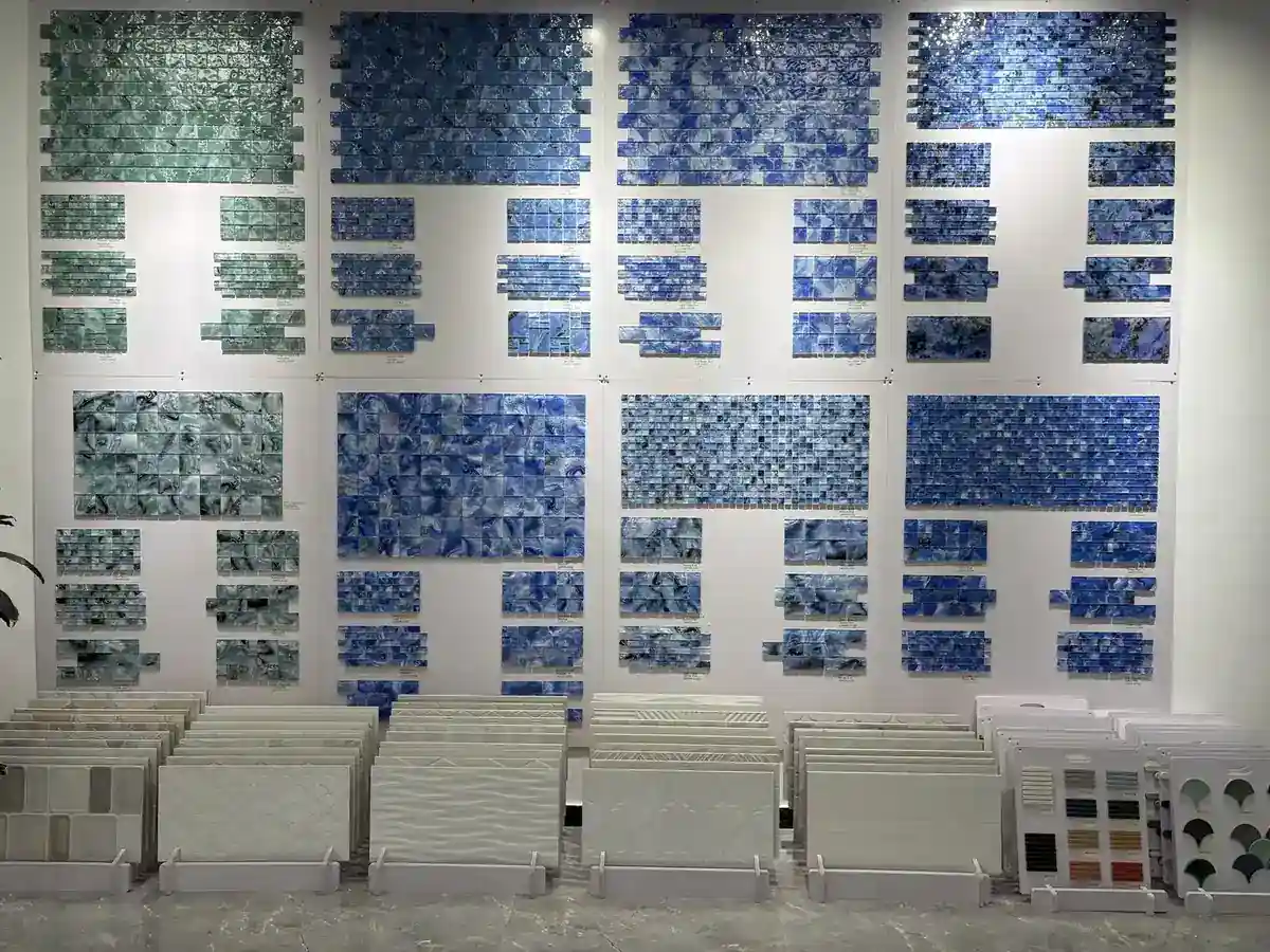 Glass mosaic sample panels laid up on the showroom wall at LSDECO