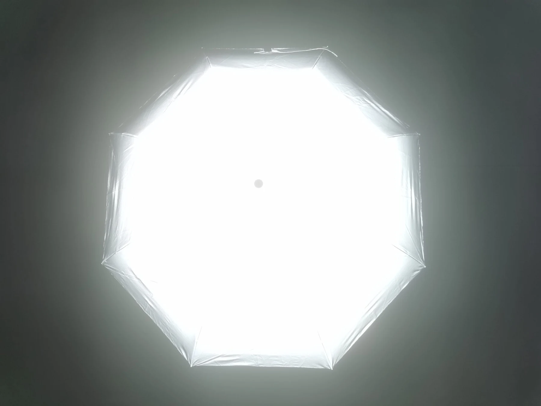Achtteiliger reflektierender Schirmbezug, im Dunkeln von oben fotografiert