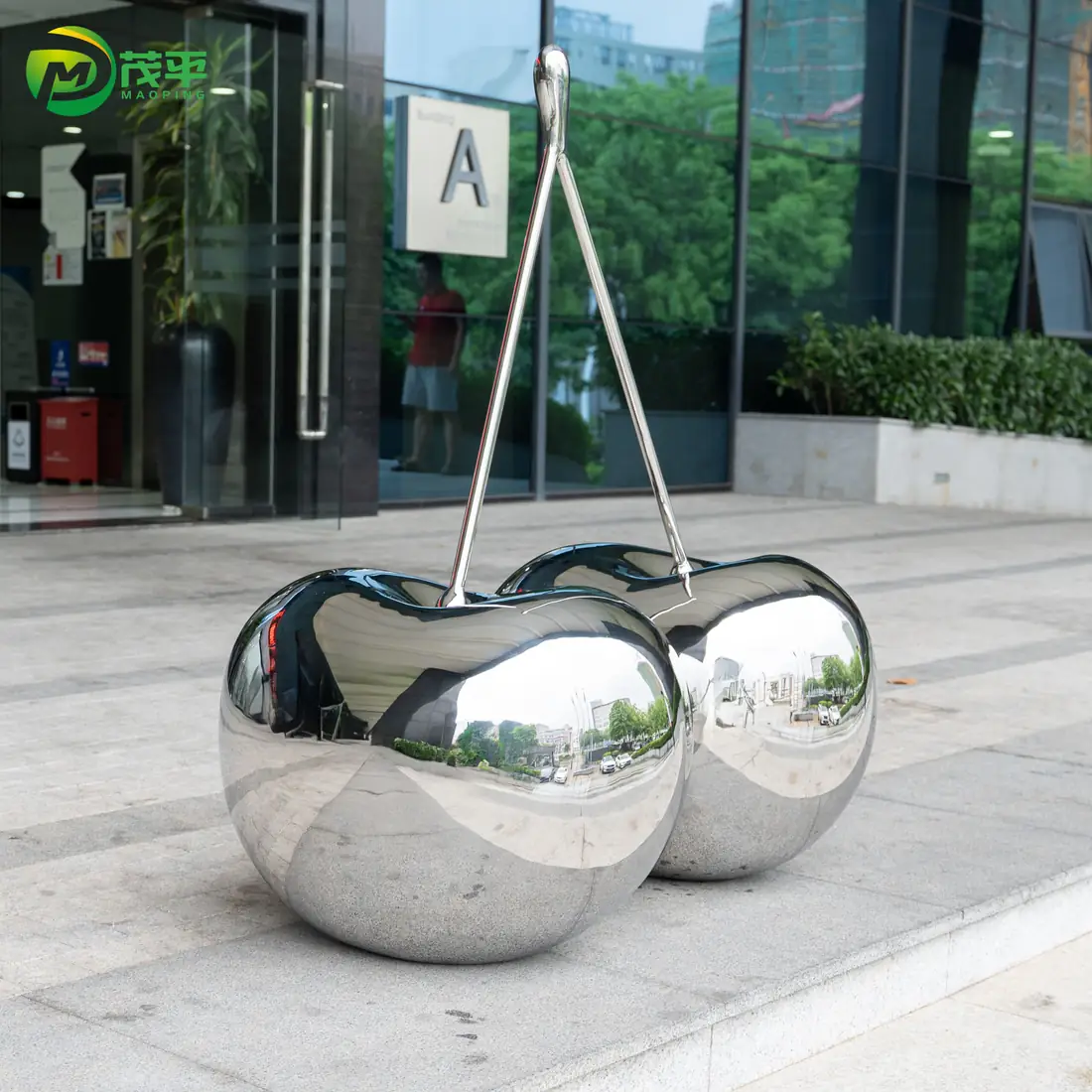 Polished cherry stainless steel sculpture