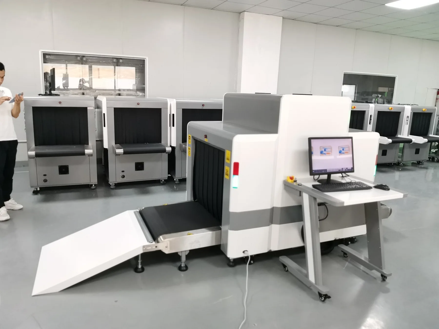 Baggage scanners under assembly, conveyors and operator consoles fitted.