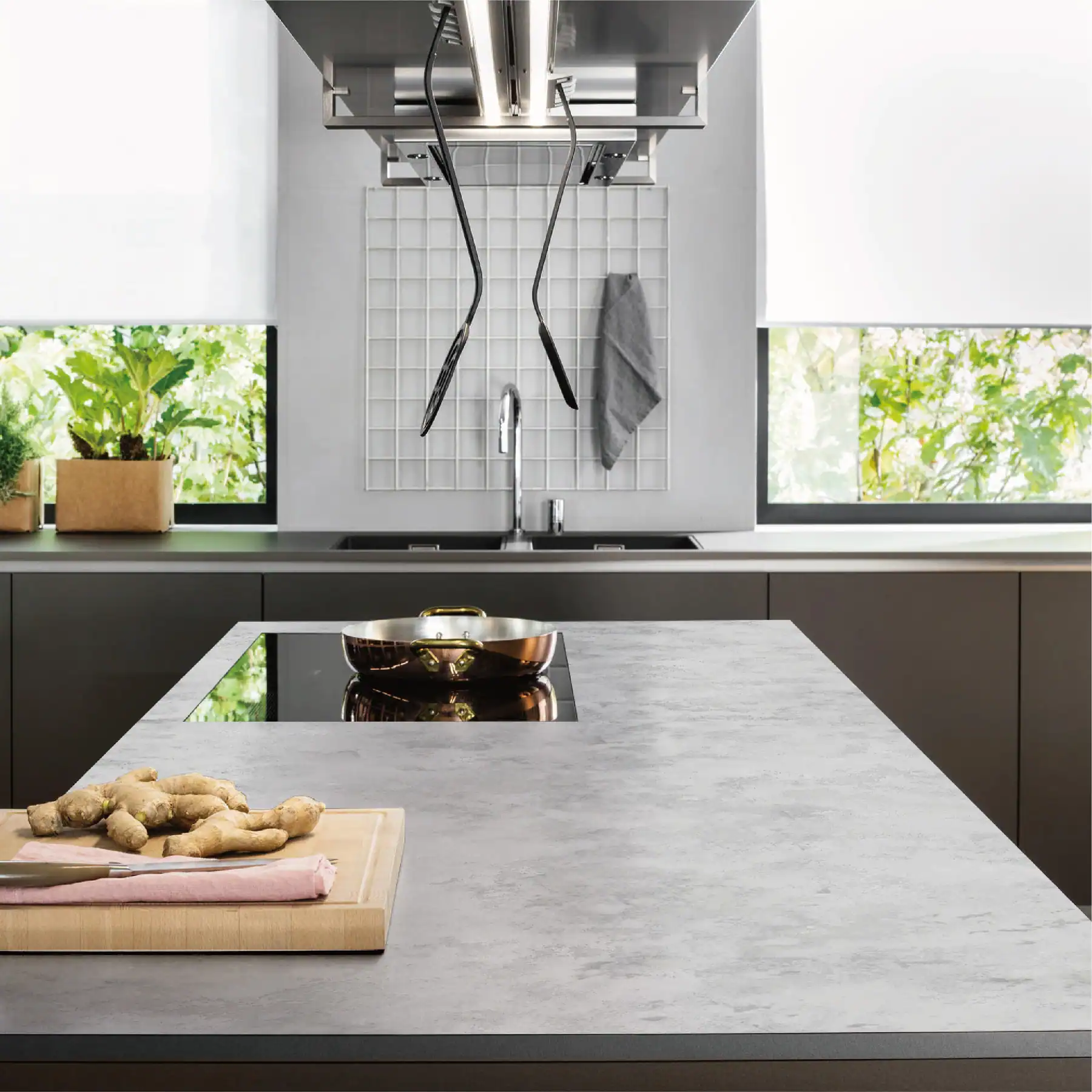 Engineered stone kitchen island worktop with induction hob in a modern kitchen