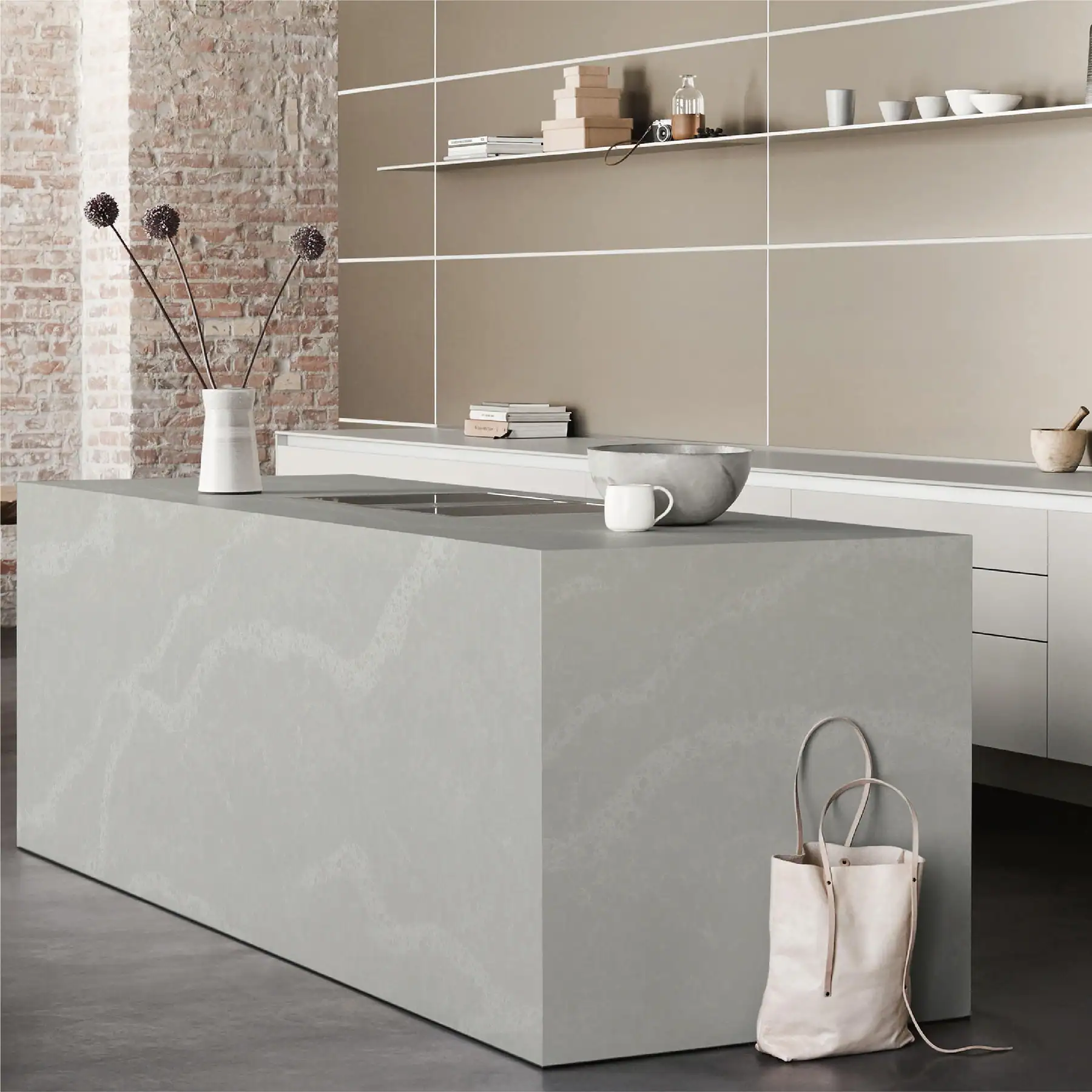 Grey quartz island with a full waterfall side panel in an open-plan kitchen