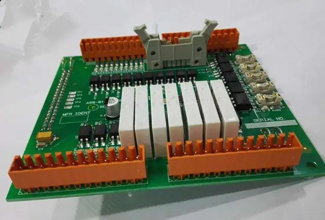 Assembled industrial IO PCBA with a relay bank and two rows of pluggable screw terminal bl