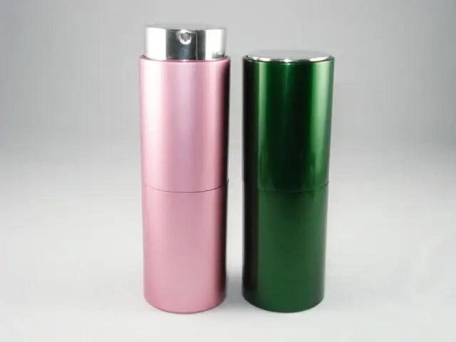 Two cylindrical cosmetic bottles, one pink with silver pump and one green with metallic ca