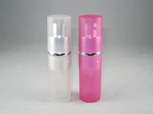 Two small cylindrical spray bottles, one frosted white and one pink, with silver collar ba