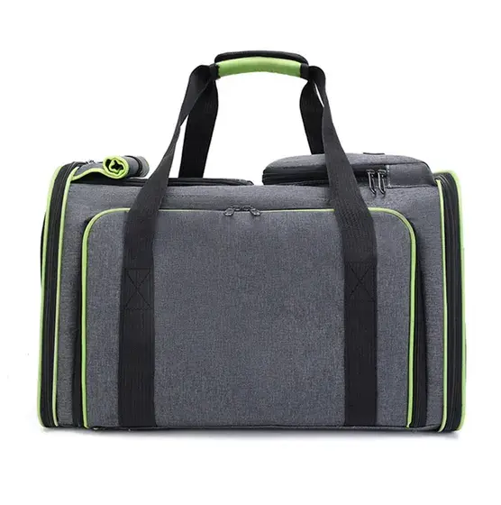 Grey fabric duffel bag with black handles and green zipper accents on a white background