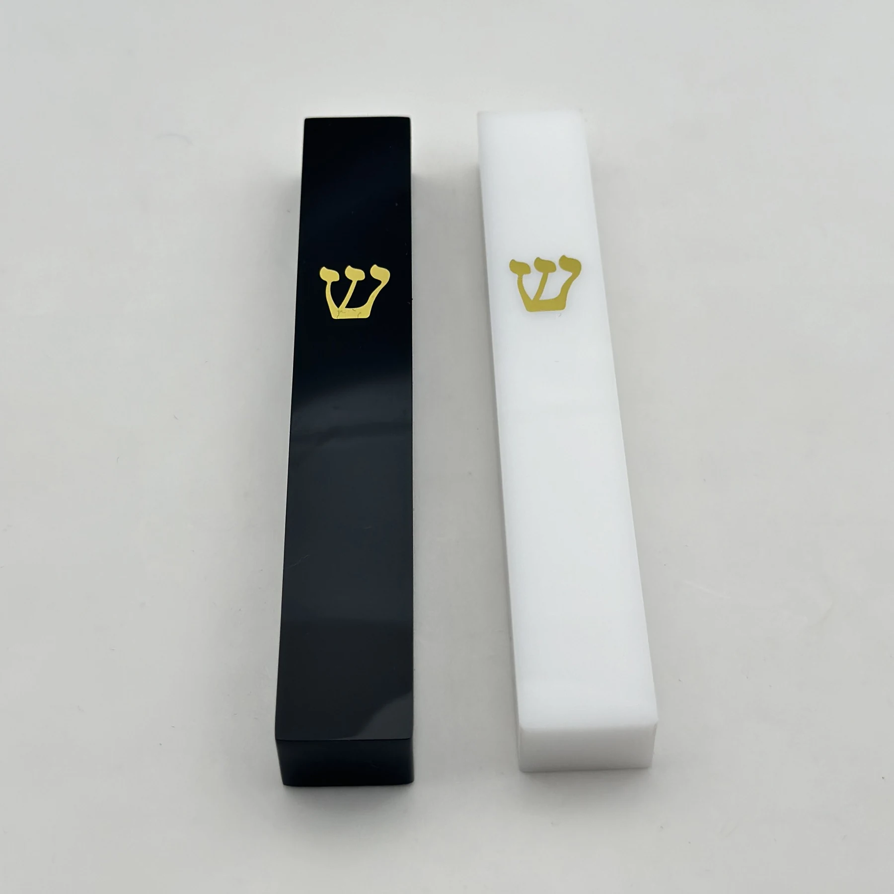Close view of the gold printed Shin on the polished acrylic mezuzah