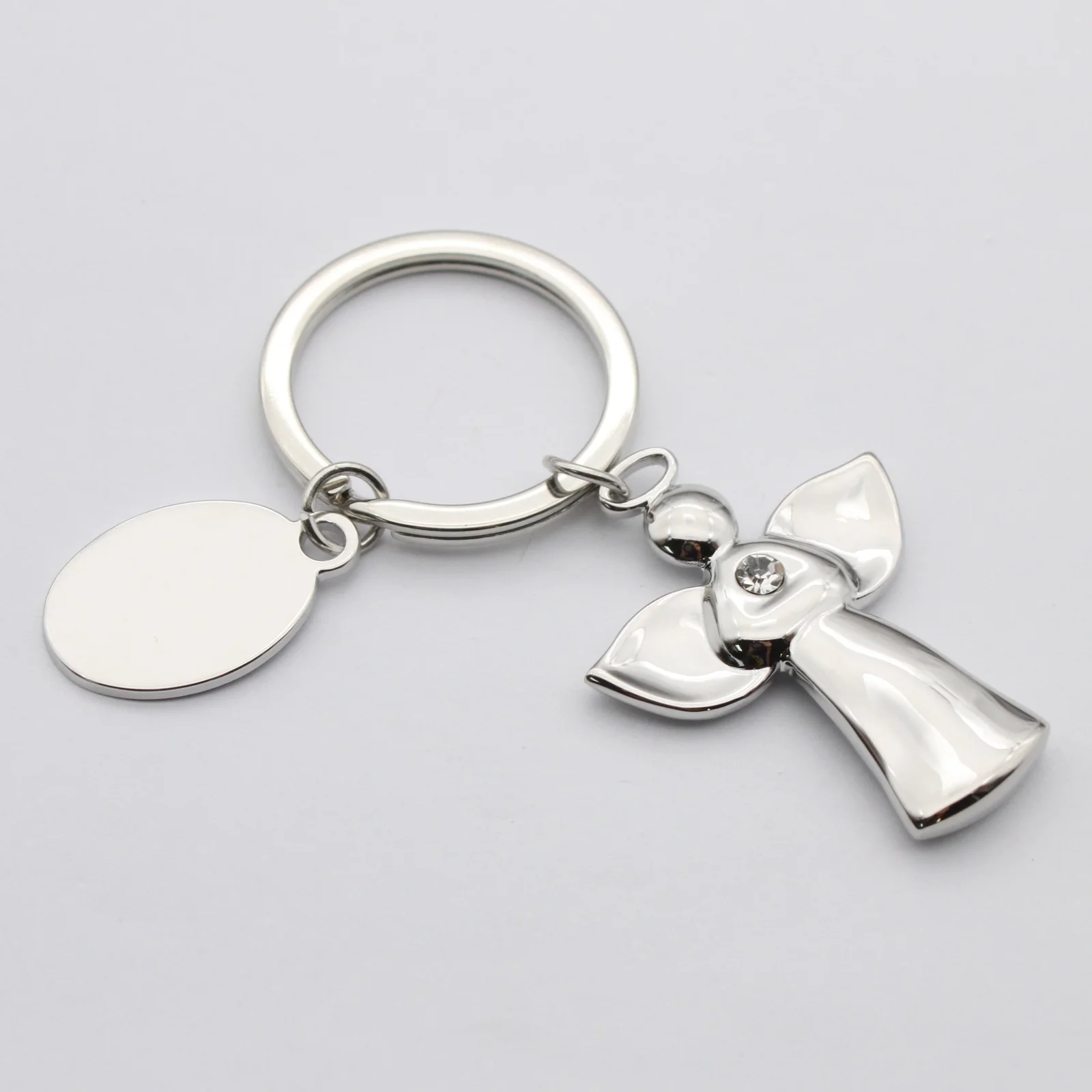 Close view of the angel charm and customisable logo charm