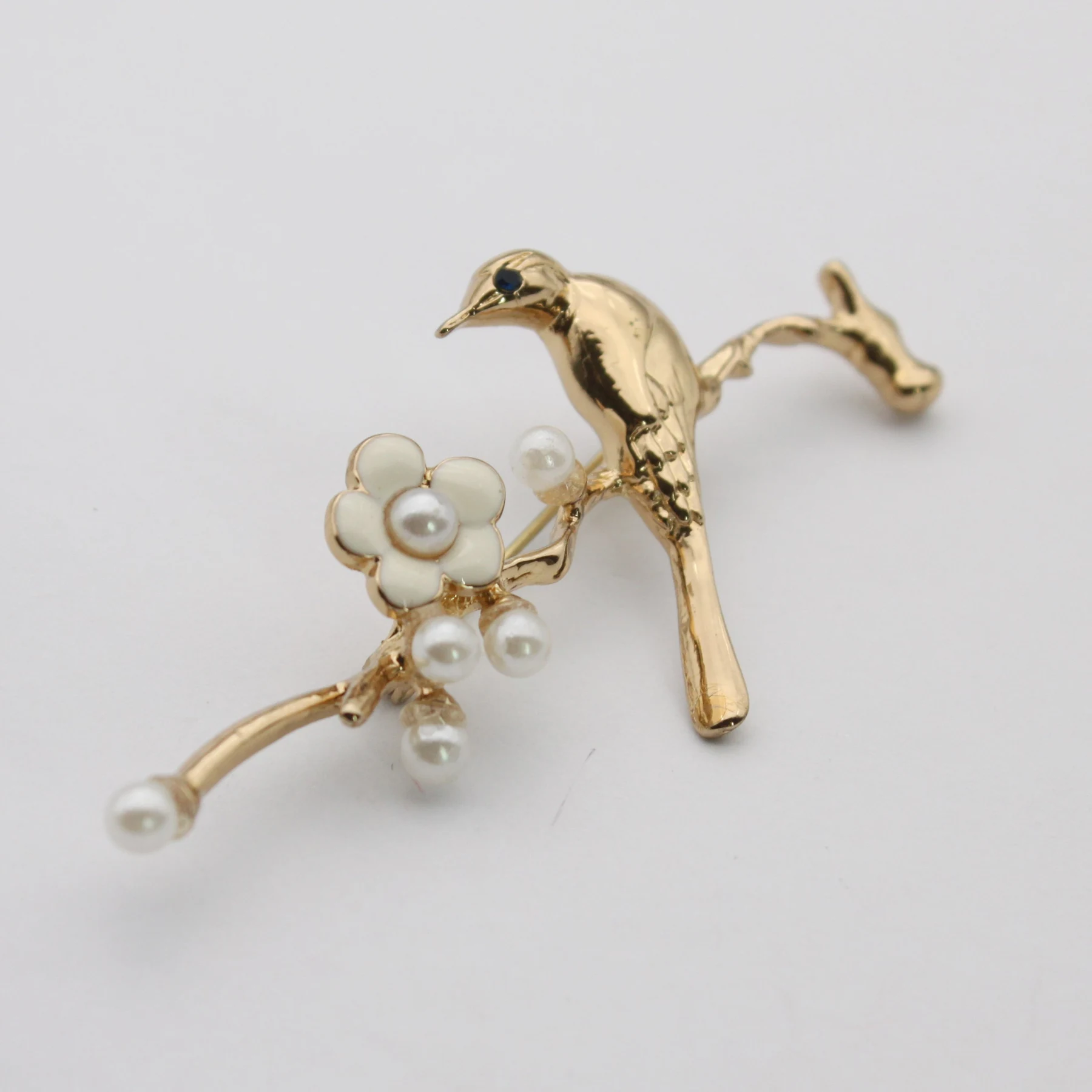 Bird and flower brooch pin shown from the front