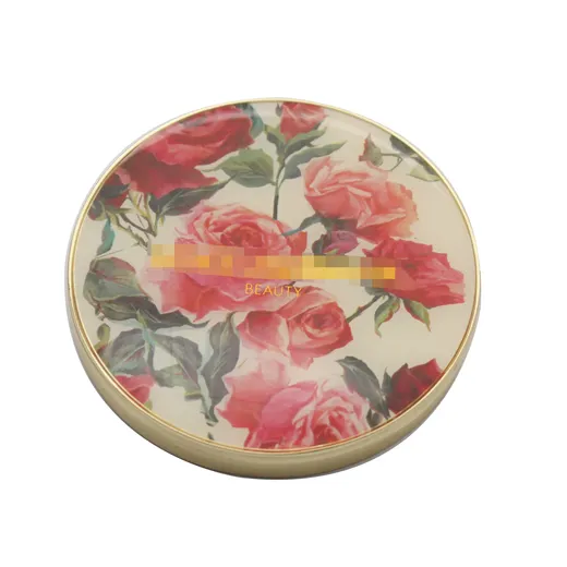 Gold plated compact mirror with flower design under an epoxy dome