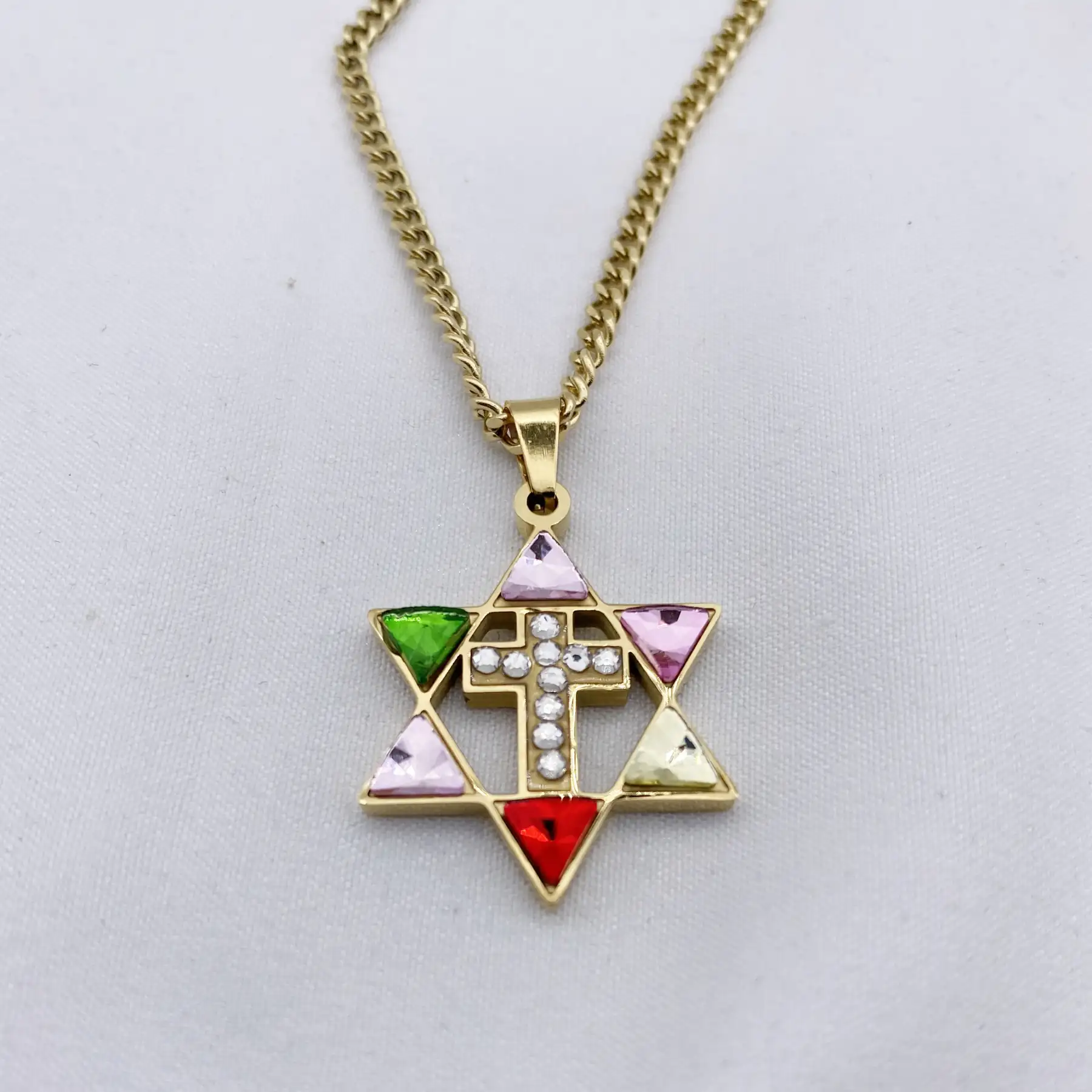 Close view of the rhinestone set triangles and central cross
