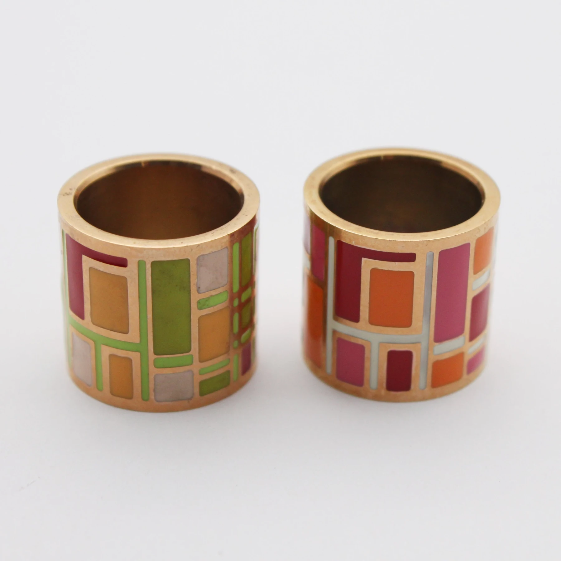 Set of custom enamel napkin rings on a studio background