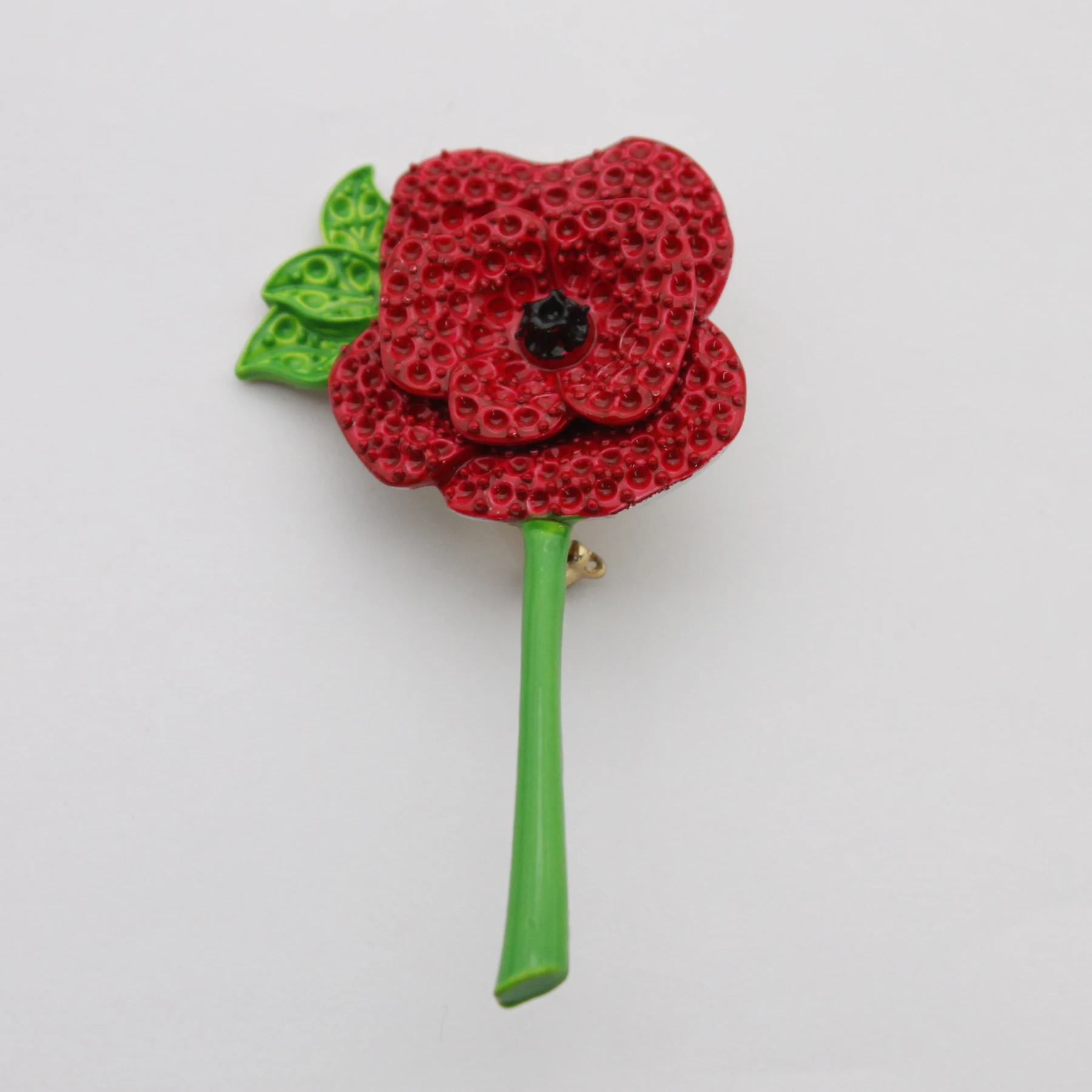 Close view of the enamel work on the poppy pin