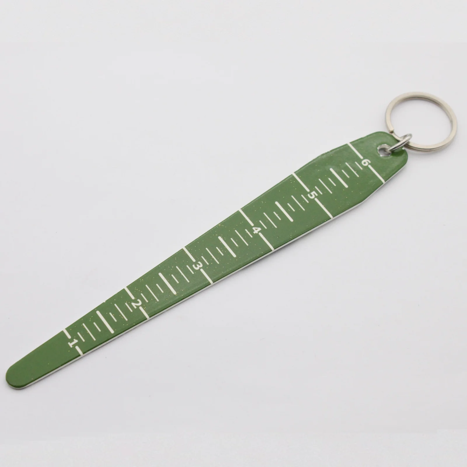 Close view of the ruler markings on the metal keyring