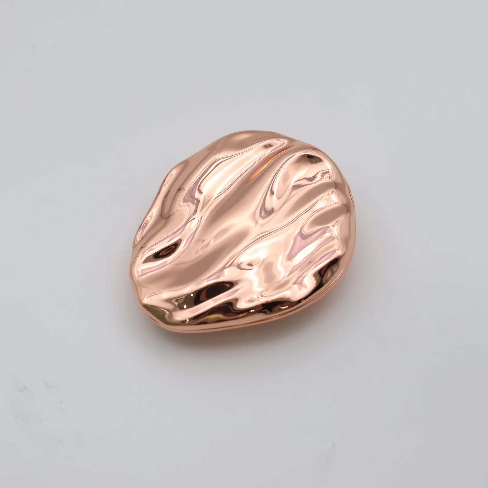 Solid perfume compact shown closed