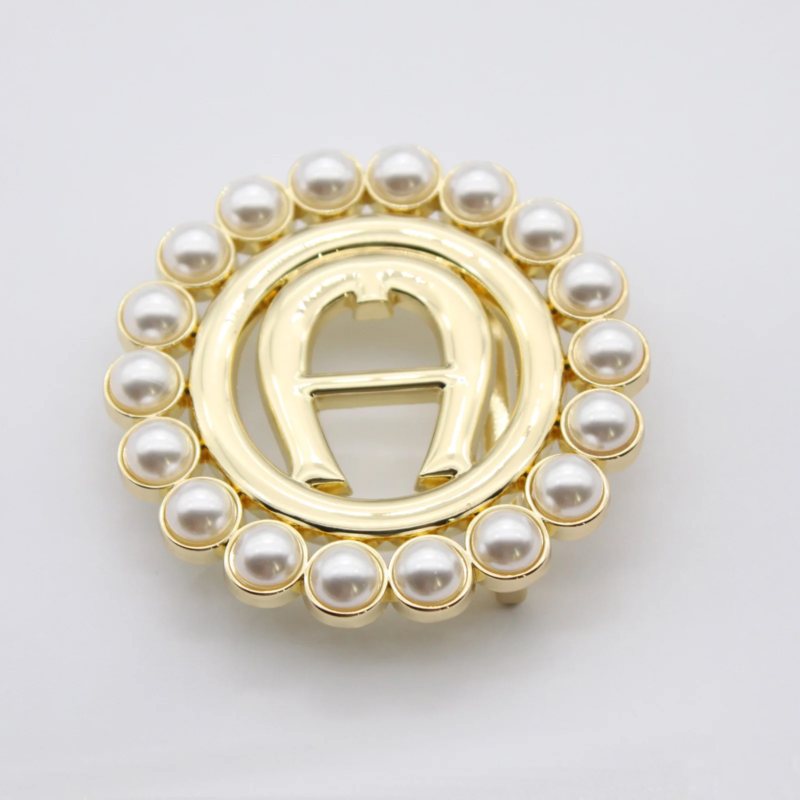 Close view of the set pearls on the gold belt buckle
