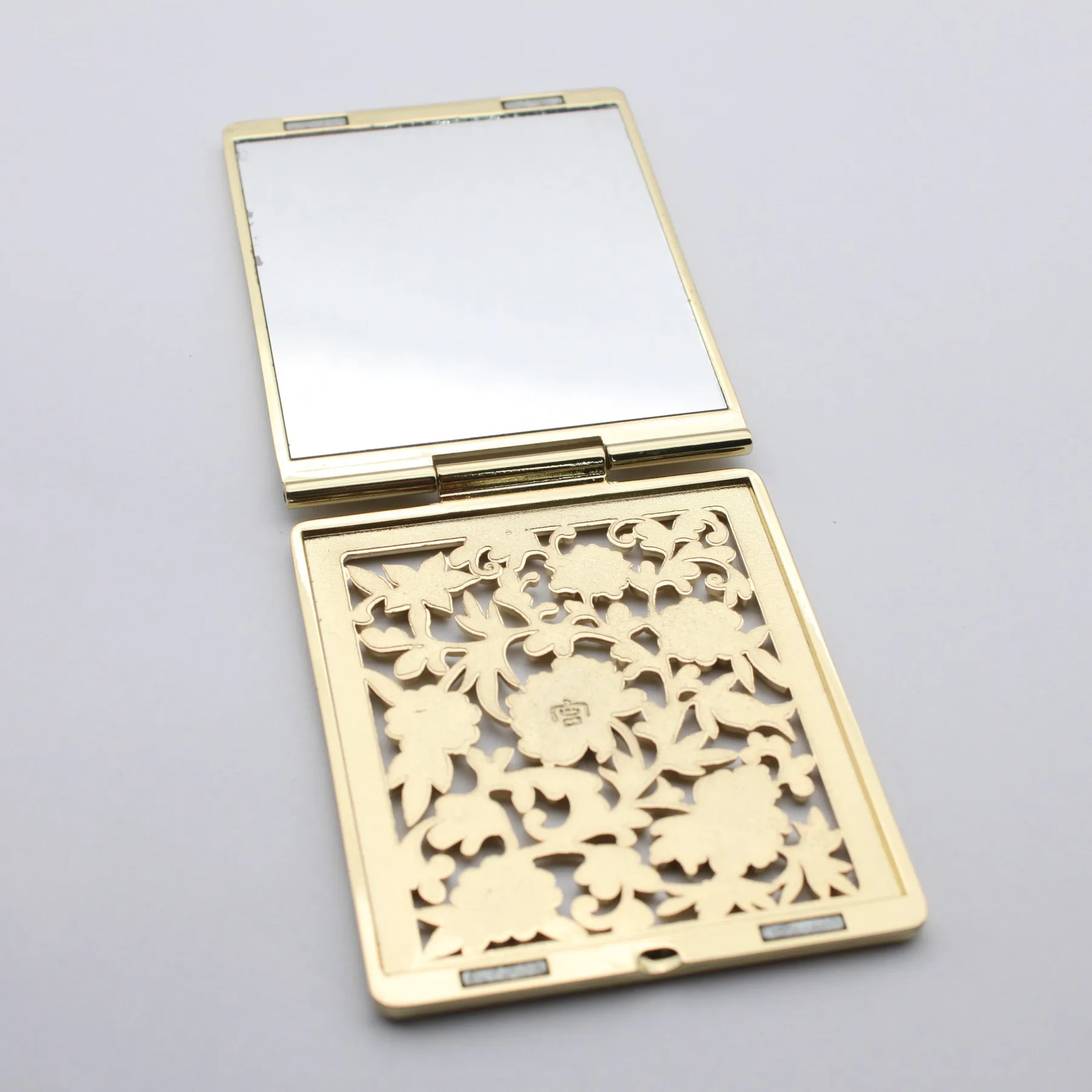 Hollowed flower pearl compact mirror shown closed