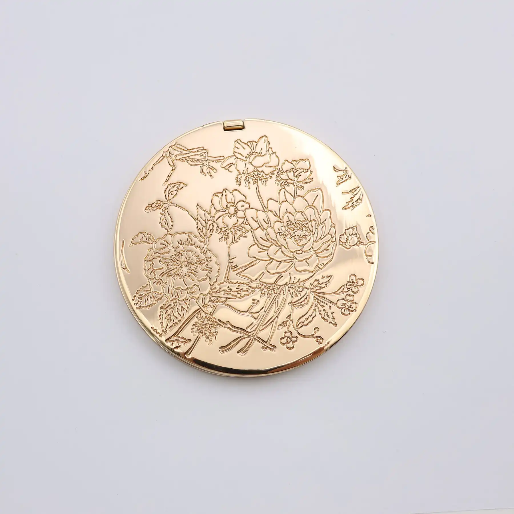 Engraved gold portable mirror shown closed