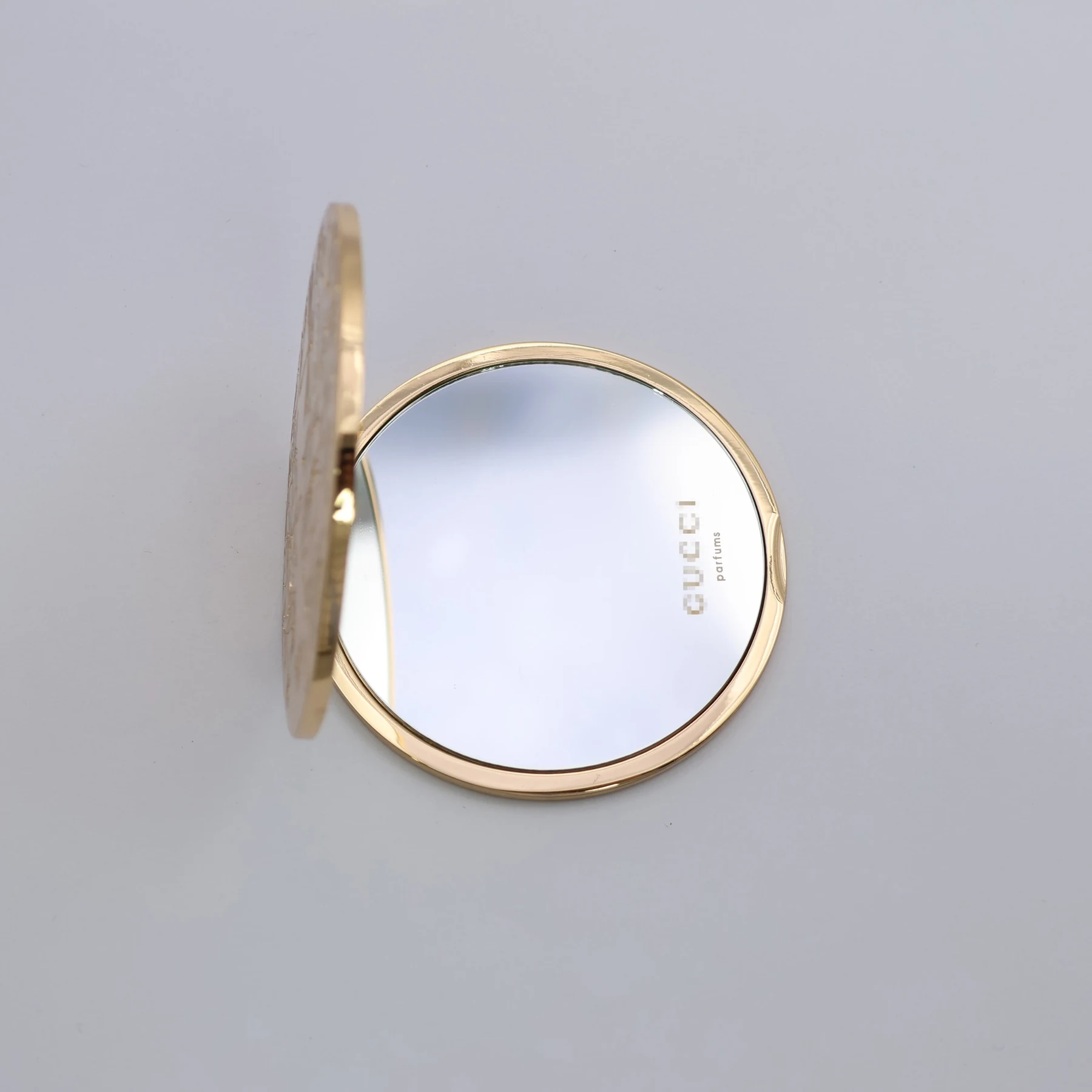 Close view of the floral engraving on the portable mirror