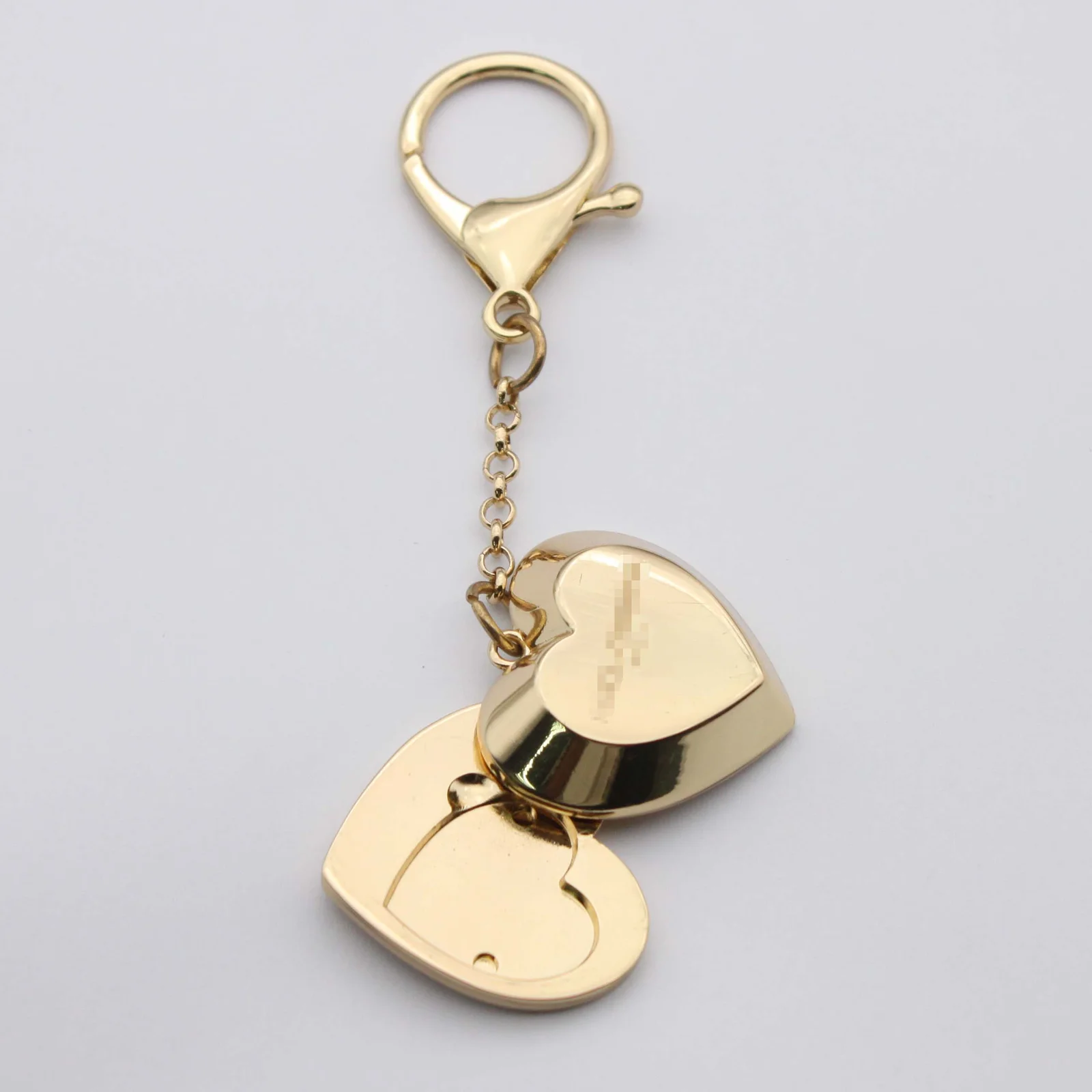 Heart aroma keyring shown opened to the fragrance pad